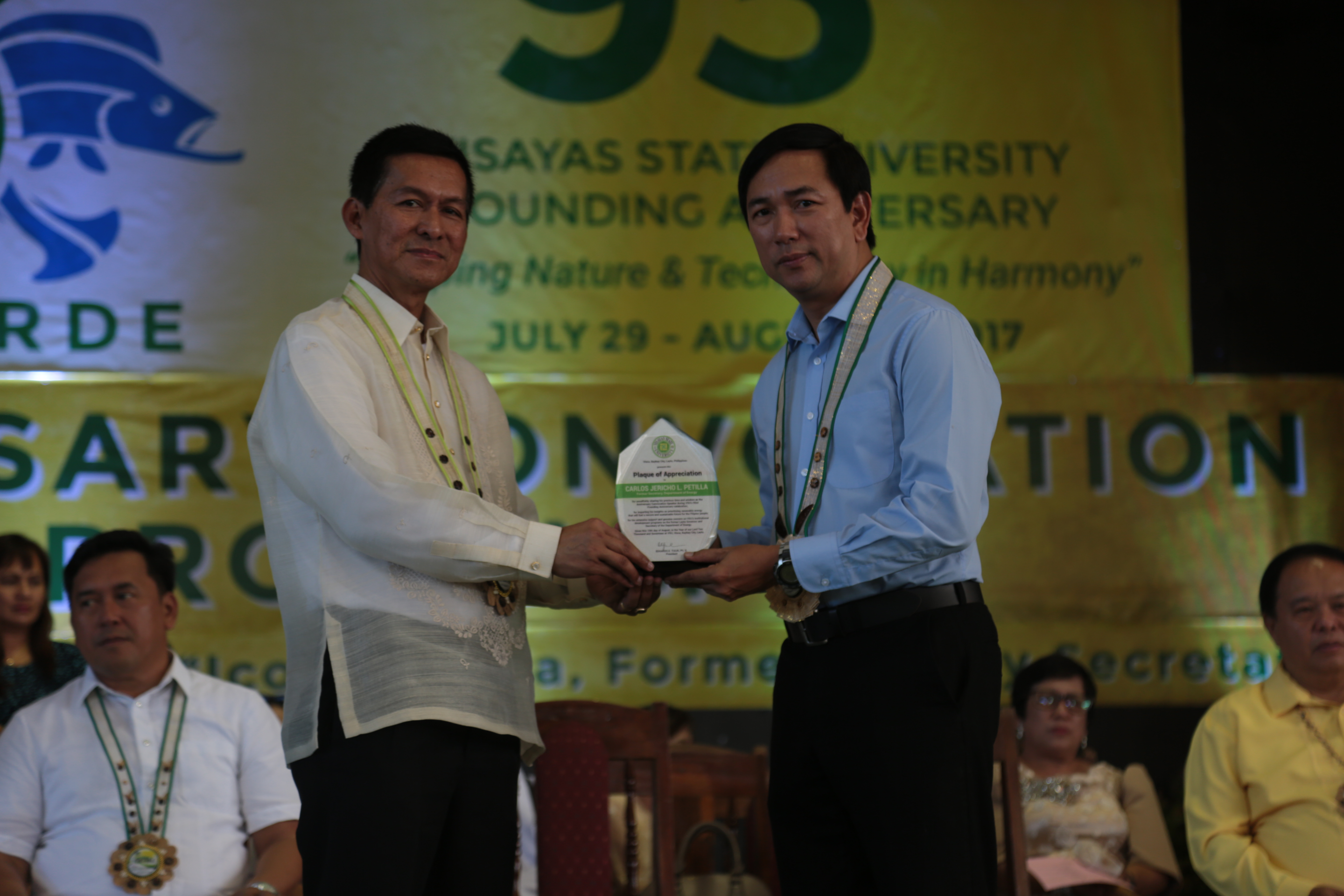 GLOBALIZATION. Former Department of Energy (DOE) Secretary and ex-Leyte Governor, Jericho 'Icot' Petilla, receiving the plaque of appreciation from University President Dr. Edgardo E. Tulin during the 93rd Anniversary Convocation. Photo by VSU Media Team